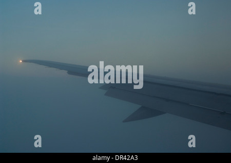 Plane flying through clouds while on approach into San Francisco, California Stock Photo