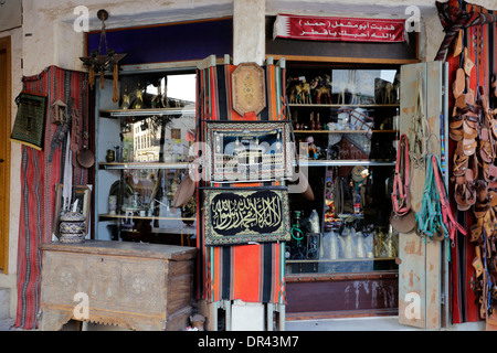 A souvenir shop selling trinkets of various age in Souq Waqif market, Doha, Qatar Stock Photo