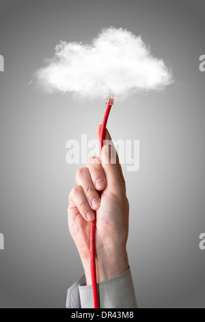 Cloud computing concept. Hand with ethernet cable connecting into cloud. Stock Photo