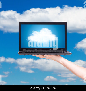 Picture of cloud from laptop screen under blue sky Stock Photo