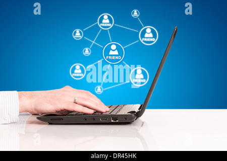 laptop business man hand touch pad, concept of technology social connection internet network on blue background Stock Photo