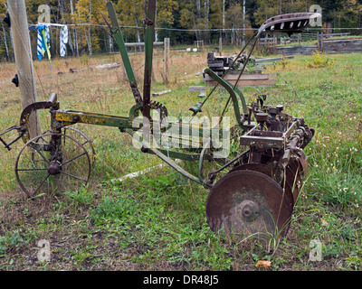 Side view of an antique 10 disk plow, on a farm near Likely, Cariboo-Chilcotin region, British Columbia Stock Photo