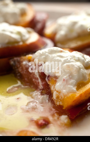 Tomatoes, peaches and burratta cheese Stock Photo