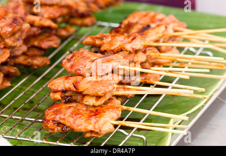 Thai style BBQ pork on metal sieve. Stock Photo