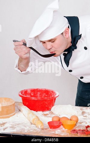 chef with large spoon on the gray background Stock Photo