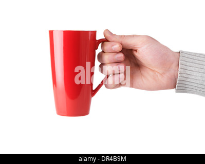 Person holding red tall tea mug in his hand isolated on white background Stock Photo