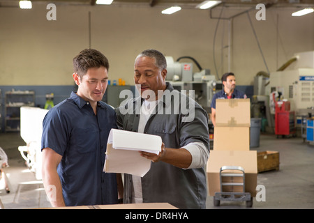 Workers talking in warehouse Stock Photo