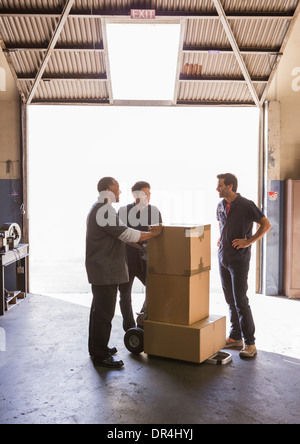 Workers talking in warehouse Stock Photo