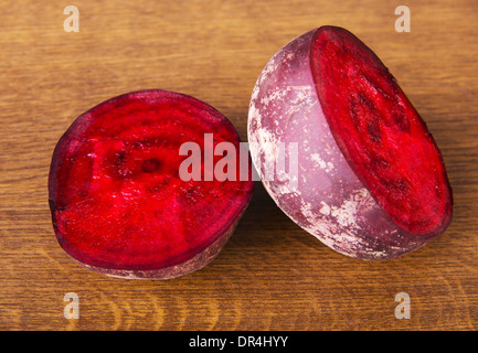 One beetroot divided into two. Over wooden background. Stock Photo