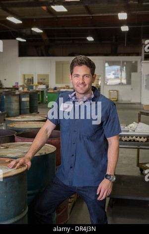 Caucasian worker smiling in warehouse Stock Photo