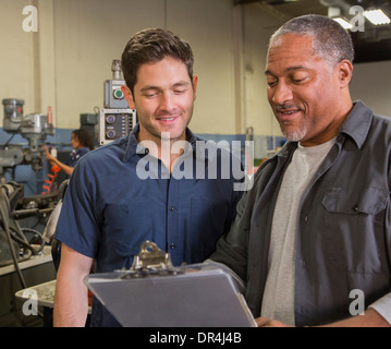 Workers talking in warehouse Stock Photo
