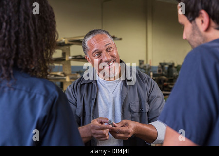 Workers talking in warehouse Stock Photo