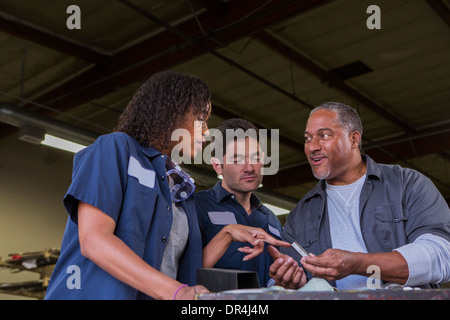 Workers talking in warehouse Stock Photo