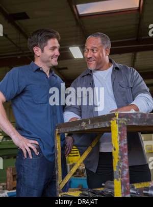 Workers talking in warehouse Stock Photo