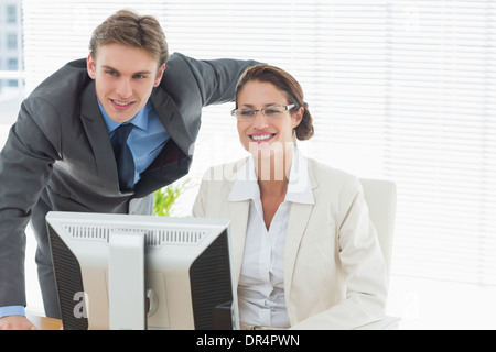 Confident smiling business couple with computer Stock Photo