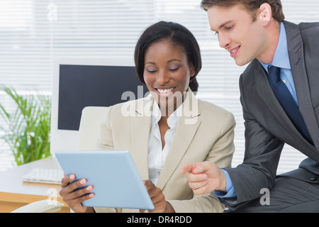 Colleagues using digital tablet in office Stock Photo