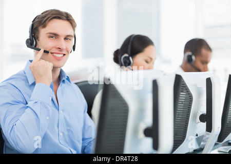 Business colleagues with headsets using computers Stock Photo