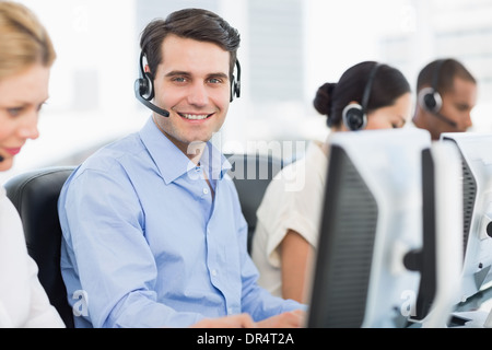 Business colleagues with headsets using computers Stock Photo