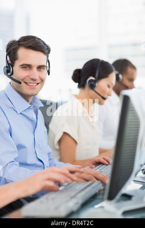 Business colleagues with headsets using computers Stock Photo