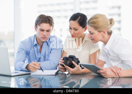 Colleagues working together at desk Stock Photo