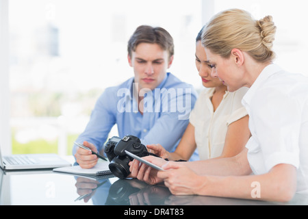 Colleagues working together at desk Stock Photo