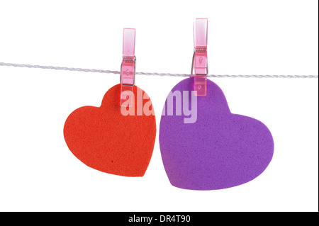 two foam shapes hearts pinned together isolated on white background Stock Photo