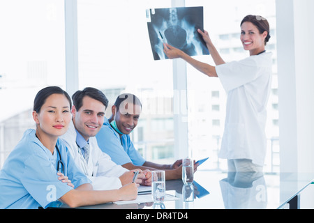 Female doctor explaining x-ray to her team Stock Photo