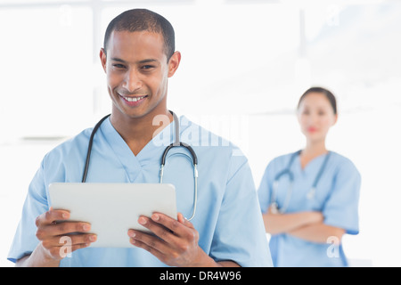 Handsome male doctor holding digital tablet Stock Photo