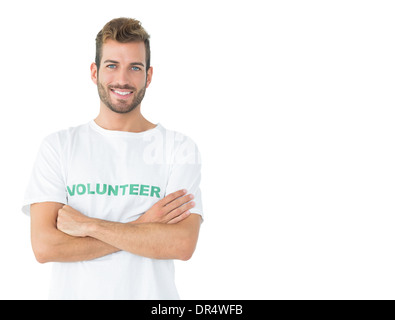 Portrait of a happy male volunteer standing with hands crossed Stock Photo