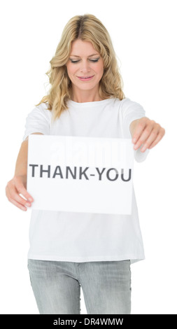 Smiling female volunteer holding 'thank you' paper Stock Photo