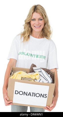 Portrait of a smiling young woman with clothes donation Stock Photo