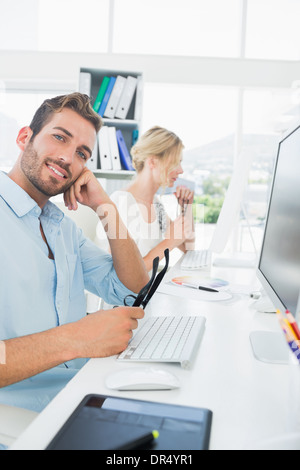 Smiling casual young couple working on computer Stock Photo