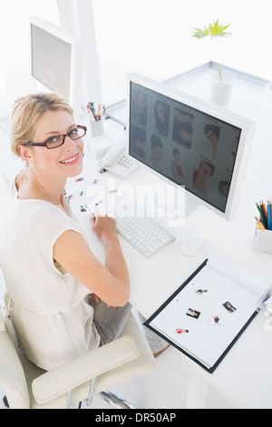 Female photo editor working on computer Stock Photo