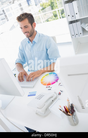 Smiling male photo editor using computer Stock Photo