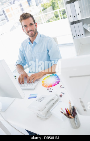 Smiling male photo editor using computer Stock Photo