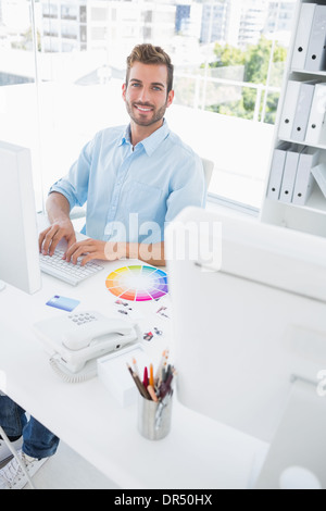 Smiling male photo editor using computer Stock Photo