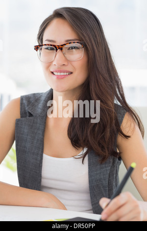 Casual female photo editor using graphics tablet Stock Photo