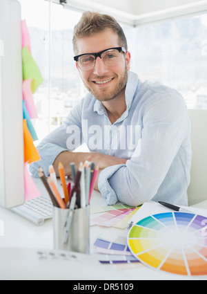Portrait of a smiling young man using computer Stock Photo