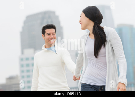 Couple holding hands in city Stock Photo