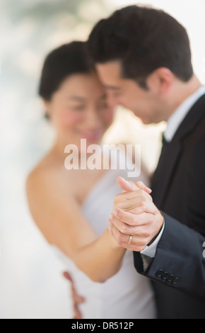 Newlywed couple dancing at wedding reception Stock Photo