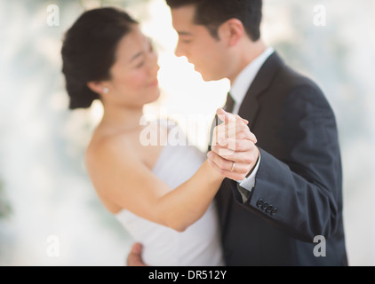 Newlywed couple dancing at wedding reception Stock Photo