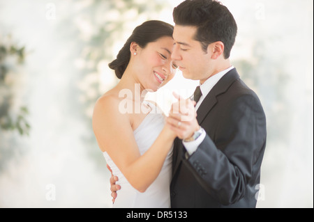 Newlywed couple dancing at wedding reception Stock Photo