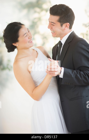 Newlywed couple dancing at wedding reception Stock Photo