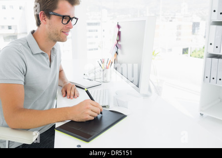 Casual male photo editor using graphics tablet Stock Photo