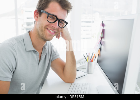 Side view of male photo editor working on computer Stock Photo