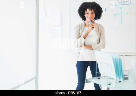 African American businesswoman smiling in office Stock Photo