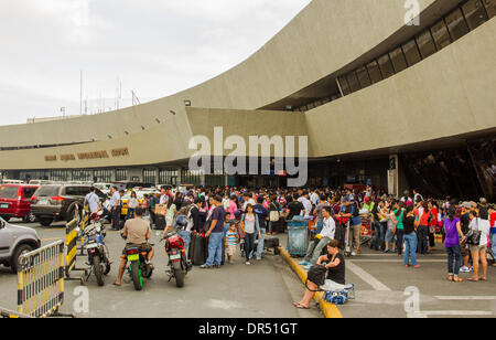 Pasay City, Philippines-January 20, 2014: Departing passengers in front of Manila International Airport Terminal-1. According to Wall Street Cheat Sheet that Manila International Airport (MAI) ranked 8th among the 10 Worst Airports in the World  published January 2014. Stock Photo