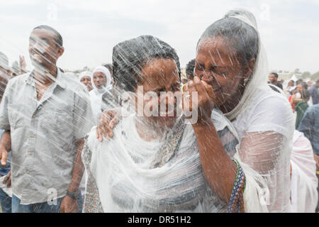 Addis Ababa, Ethiopia . 19th Jan, 2014. Holy water is sprayed onto the crowd attending Timket celebrations of Epiphany, commemorating the baptism of Jesus, on January 19, 2014 in Addis Ababa.  Credit:  Dereje Belachew/Alamy Live News Stock Photo