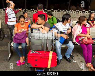 Pasay City, Philippines-January 20, 2014: Departing passengers in front of Manila International Airport Terminal-1. According to Wall Street Cheat Sheet that Manila International Airport (MAI) ranked 8th among the 10 Worst Airports in the World  published January 2014. Stock Photo