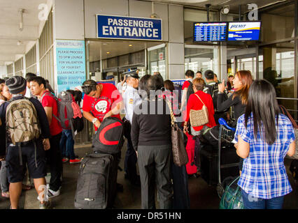 Pasay City, Philippines-January 20, 2014: Departing passengers about to enter the Manila International Airport Terminal-1 departure area. According to Wall Street Cheat Sheet that Manila International Airport (MAI) ranked 8th among the 10 Worst Airports in the World  published January 2014. Stock Photo